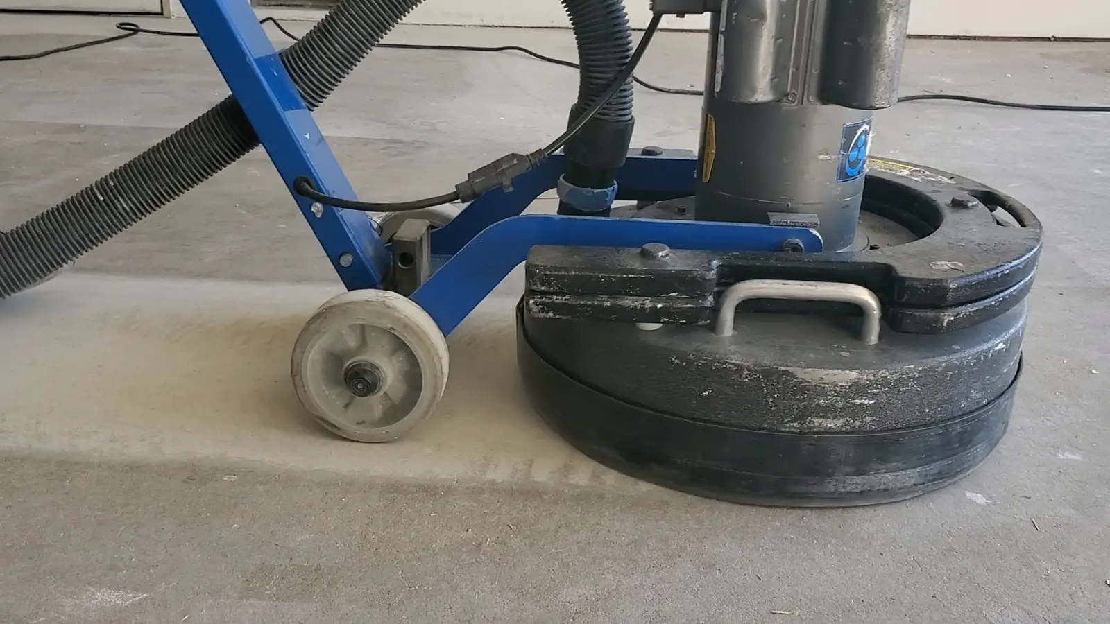 Diamond grinder preparing a concrete slab for an epoxy coating
